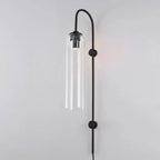 Clear glass on the Clérachic mouth-blown wall sconce with a black body, the metal sleeve visible at the top of the cylinder.
