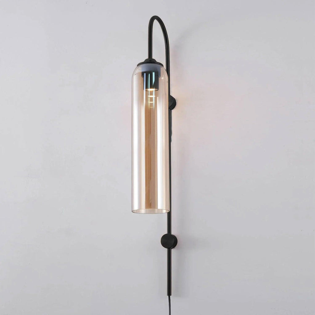 Amber glass paired with the black body of the Clérachic mouth-blown wall sconce, a warm reflection running down the glass.