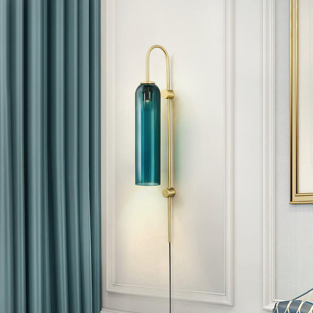 Clérachic mouth-blown glass wall sconce in teal on a white panelled wall, between a teal curtain and a gold-framed mirror.