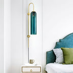 Clérachic mouth-blown glass wall sconce hung beside a teal velvet headboard, clearing the nightstand without crowding it.