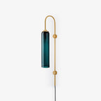 Clérachic mouth-blown glass wall sconce in deep teal on gold, photographed small in frame to show the full 80 cm drop.