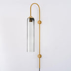 Clérachic mouth-blown glass wall sconce in smoke grey on gold, the metal bulb sleeve just visible through the pale glass.
