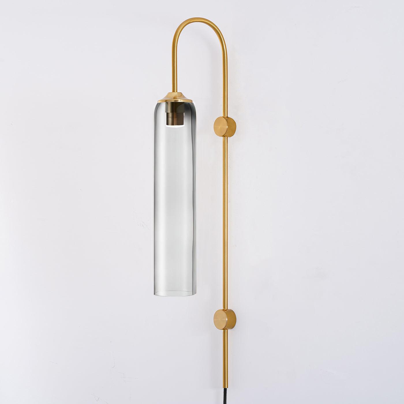 Clérachic mouth-blown glass wall sconce in smoke grey on gold, the metal bulb sleeve just visible through the pale glass.