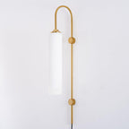 Clérachic mouth-blown glass wall sconce in milky white on gold, unlit, the glass reading flat and opaque by day.