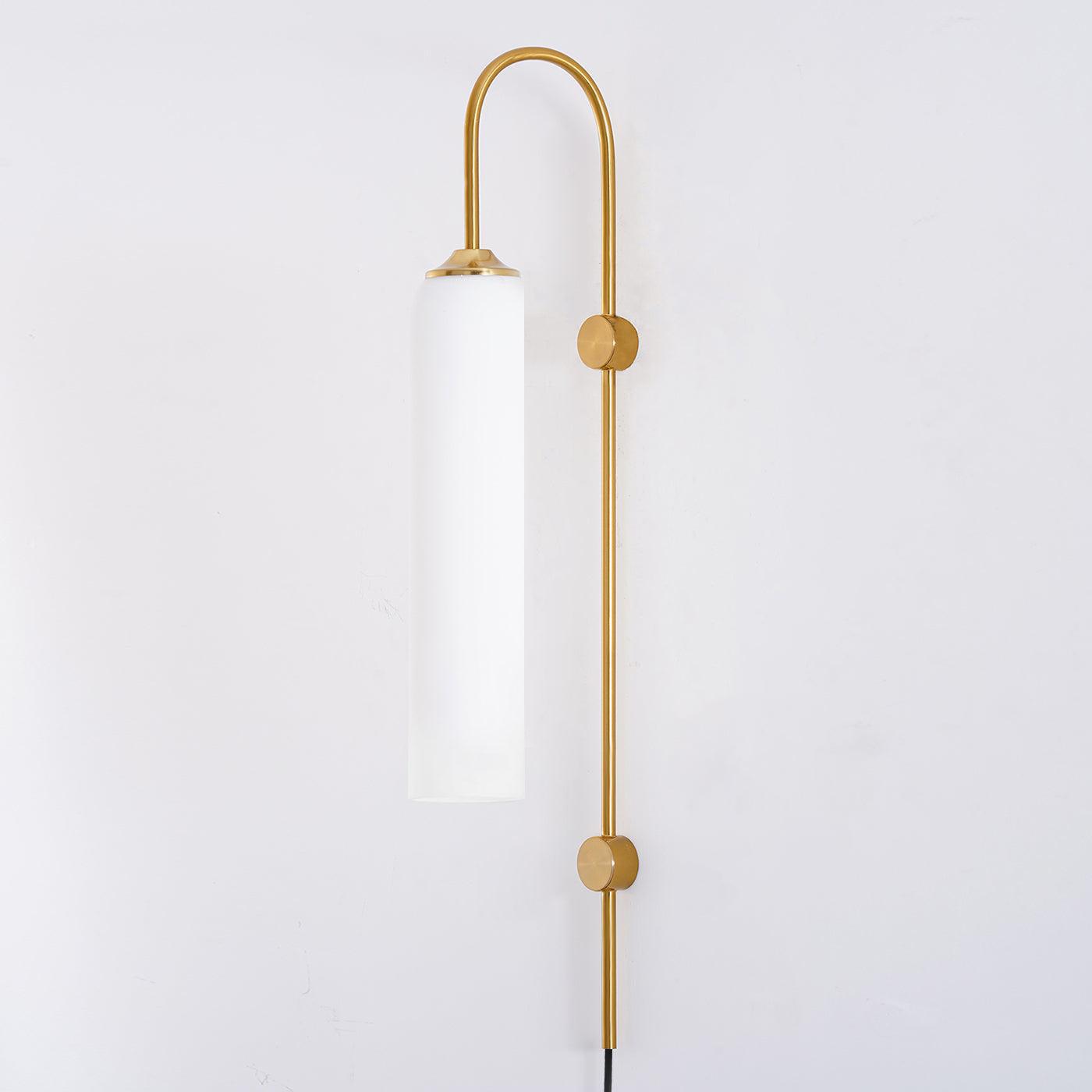 Clérachic mouth-blown glass wall sconce in milky white on gold, unlit, the glass reading flat and opaque by day.