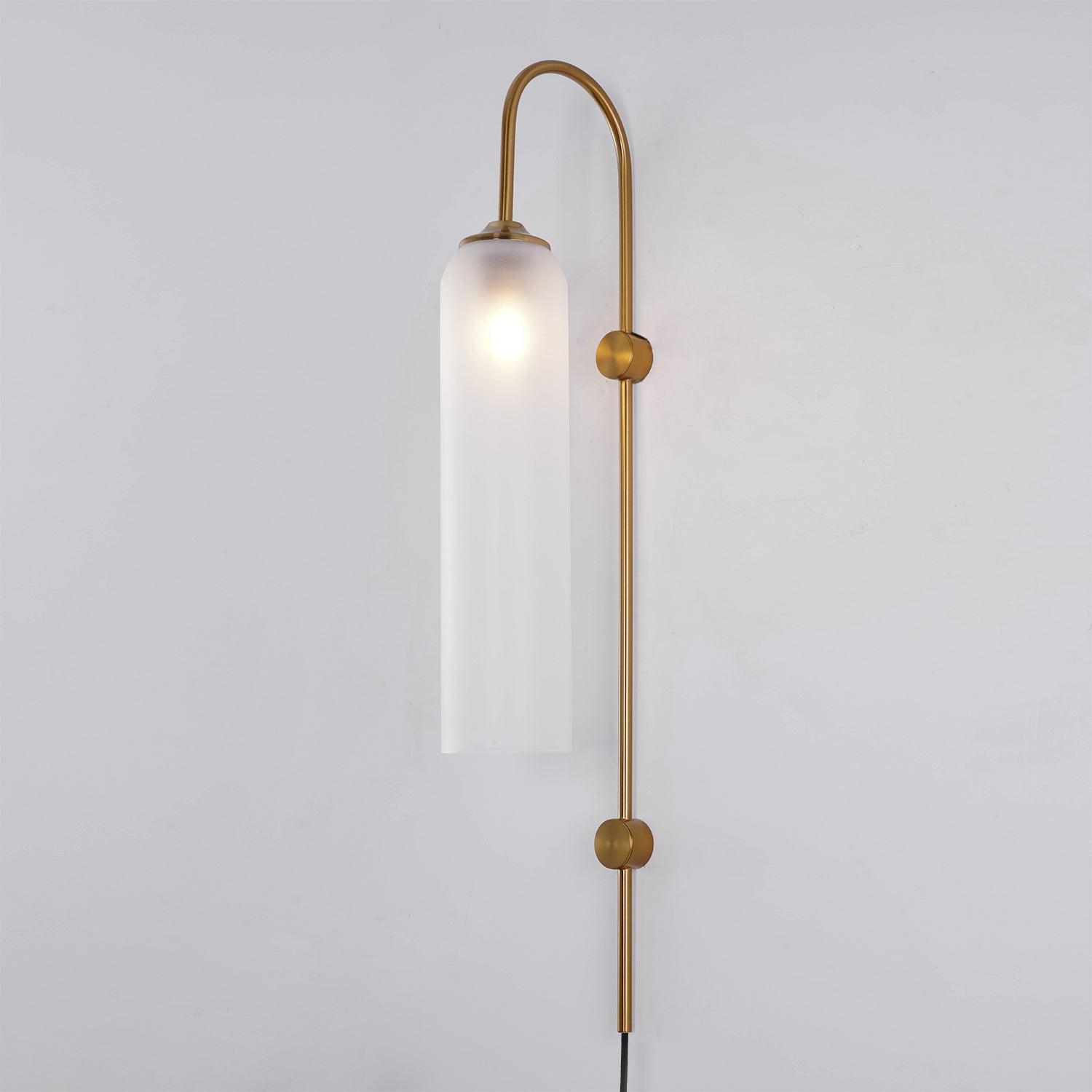 Clérachic mouth-blown glass wall sconce in frosted white on gold, the bulb blooming as a soft halo near the top.