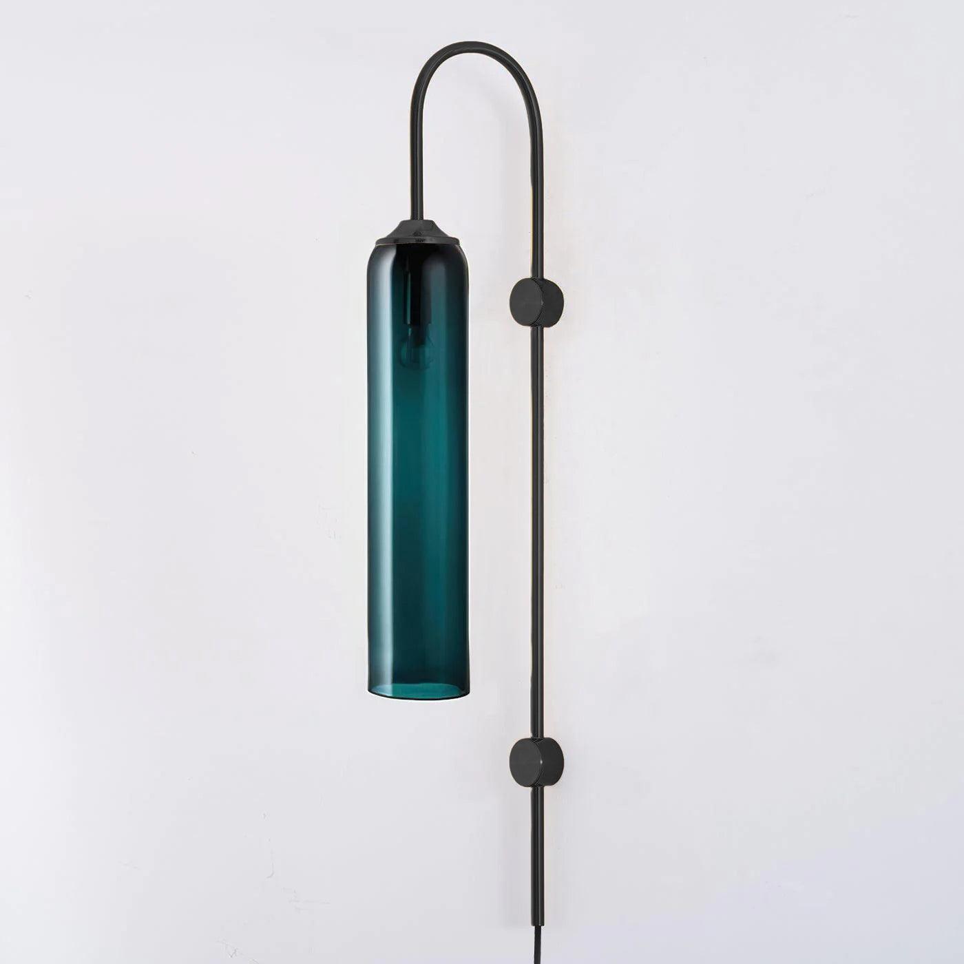 Clérachic mouth-blown glass wall sconce in deep teal on black, unlit, its gooseneck arching over the top of the shade.