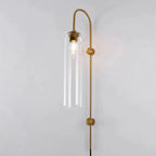 Clérachic mouth-blown glass wall sconce in clear glass on gold, the whole bulb on show inside the open cylinder.