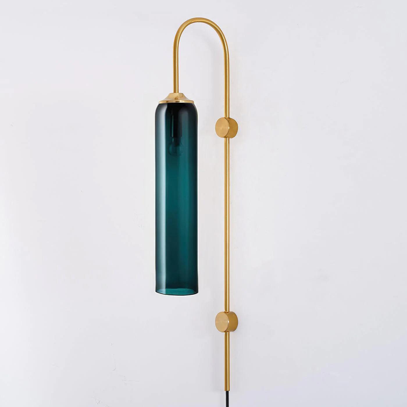Clérachic mouth-blown glass wall sconce in deep teal on gold, unlit, hanging clear of the wall on its arched arm.