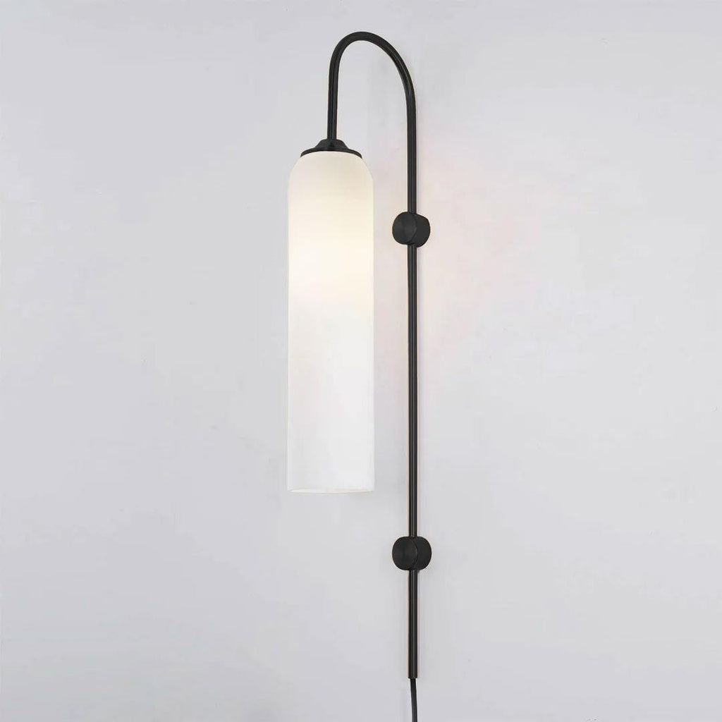 Clérachic mouth-blown glass wall sconce in opal white on black, unlit, the shade reading as a plain white column.