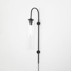 Clérachic mouth-blown glass wall sconce in clear glass on black, unlit, showing the chrome sleeve above the bulb.