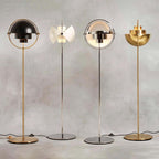 All four finishes of the Clérachic floor lamp side by side: Black & Brass, White & Chrome, Chrome and Brass.
