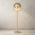 Full length against a warm plaster wall, the Clérachic floor lamp in Brass stands 160 cm (63 in) on its round base.