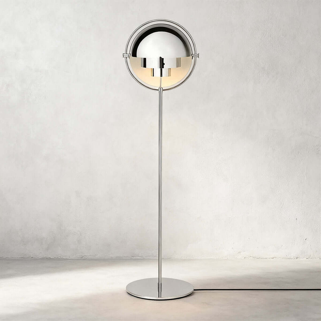 Photographed head-on against a pale wall, the Clérachic floor lamp in Chrome is polished from shades to base.