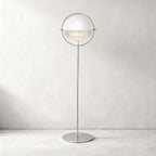 Gloss white shades and a polished chrome ring give this Clérachic floor lamp in White & Chrome a crisp look on a pale wall.