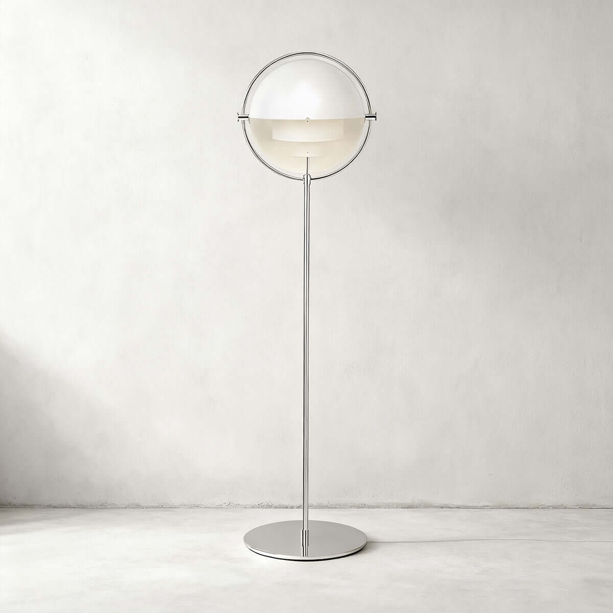 Gloss white shades and a polished chrome ring give this Clérachic floor lamp in White & Chrome a crisp look on a pale wall.