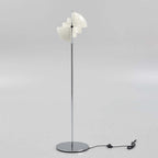 Shades rotated open on the Clérachic floor lamp in White & Chrome, exposing the two fixed inner cylinders inside the ring.