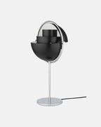 In Black & Chrome, the Clérachic table lamp has both quarter-sphere shades rotated open, letting light spread sideways as well as down.