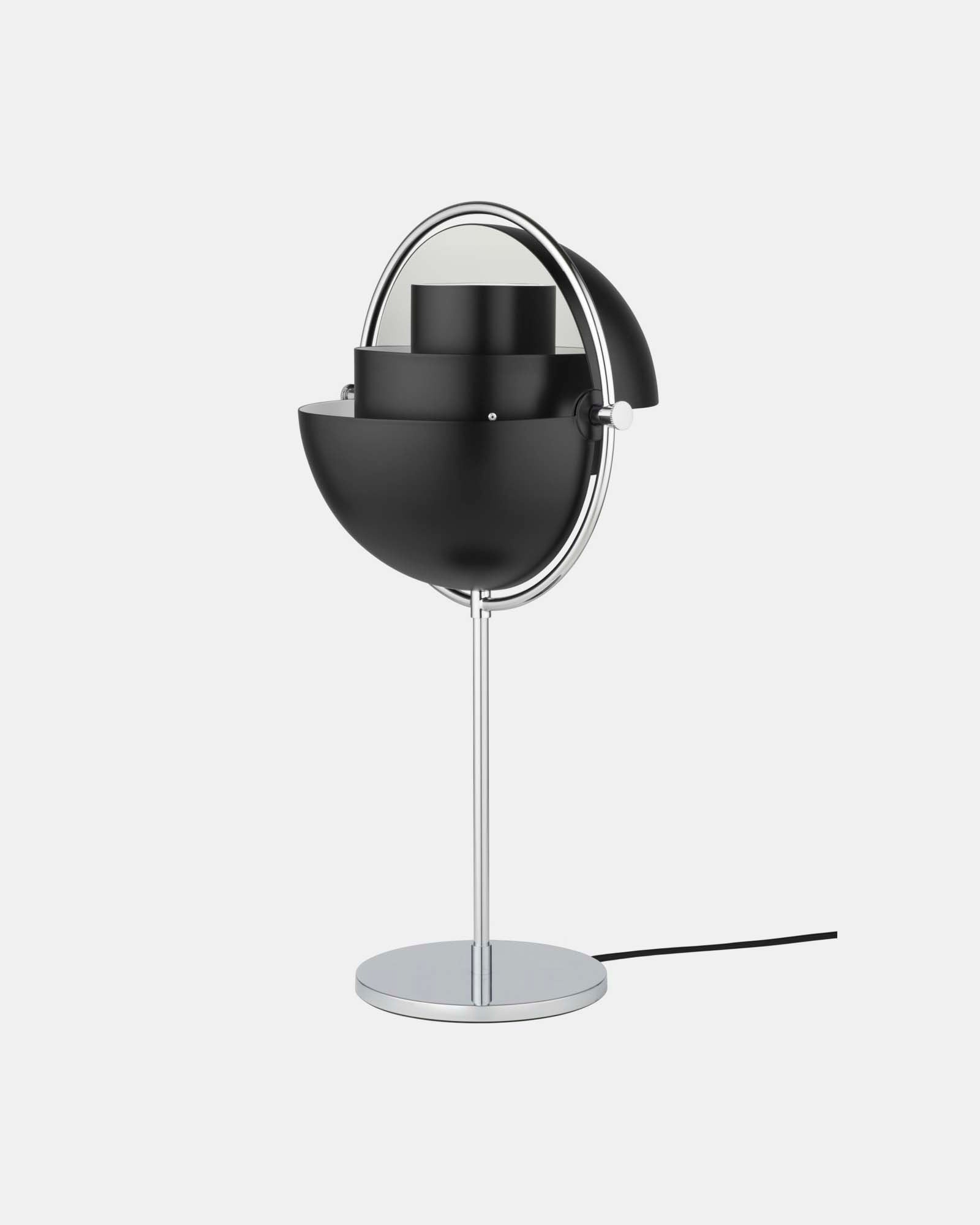 In Black & Chrome, the Clérachic table lamp has both quarter-sphere shades rotated open, letting light spread sideways as well as down.