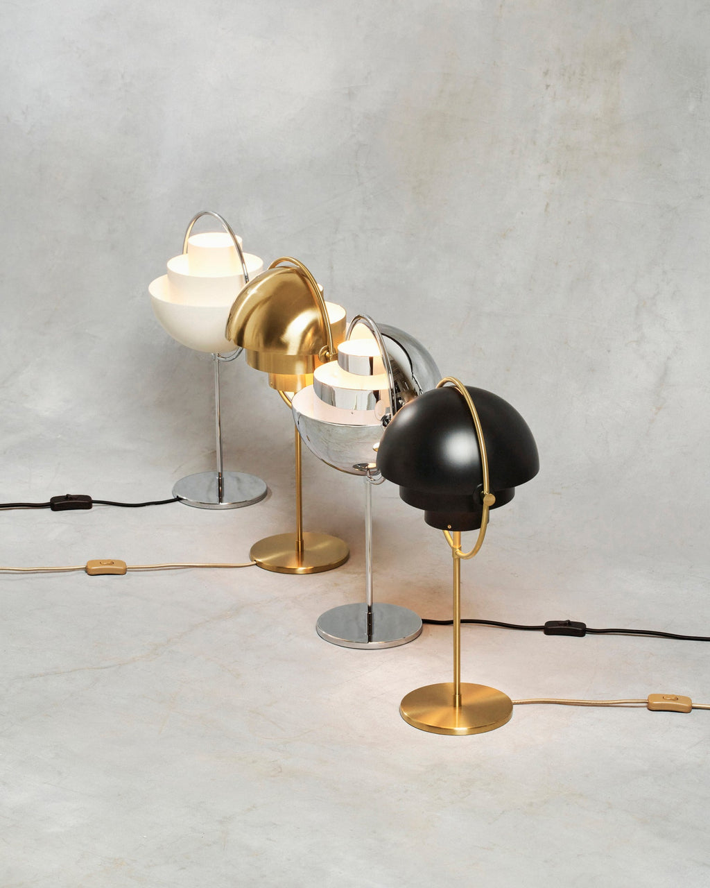 Cords and inline rocker switches on show, four Clérachic table lamps stand side by side, each textile cable colour matched to its finish.