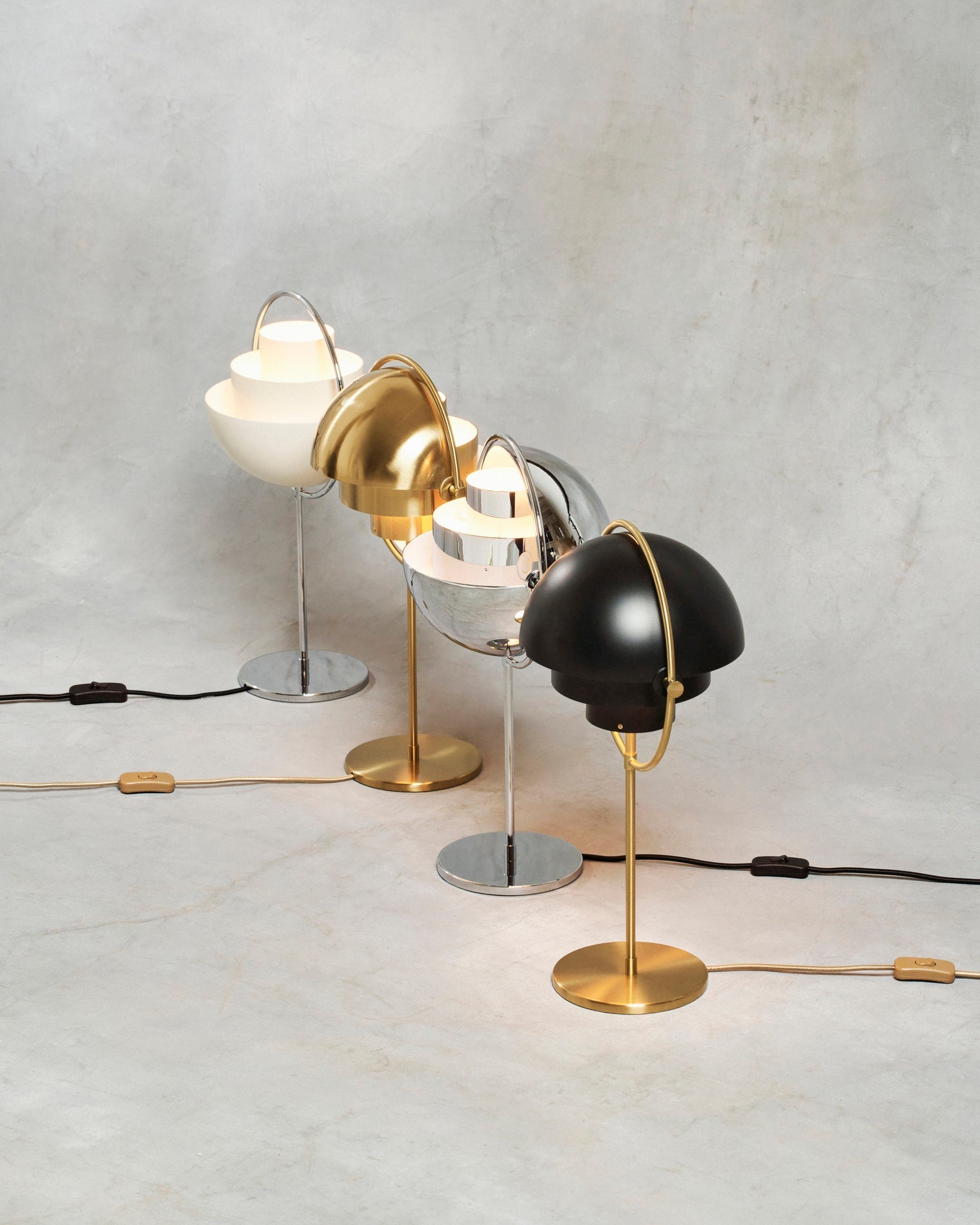 Cords and inline rocker switches on show, four Clérachic table lamps stand side by side, each textile cable colour matched to its finish.