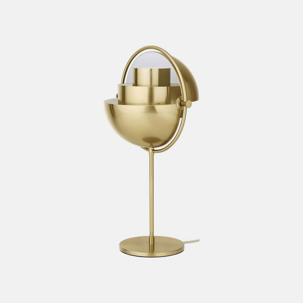 With both shades rotated open, this Brass Clérachic table lamp shows the two fixed inner cylinders that sit inside the ring and shape the light.