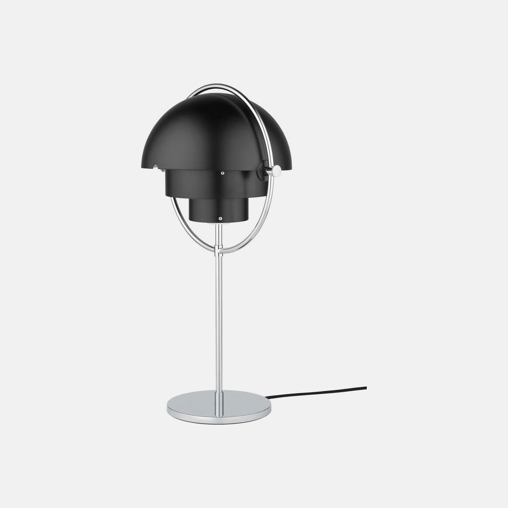 Seen straight on in Black & Chrome, the Clérachic table lamp has both shades rotated back, exposing the two fixed inner cylinders at its centre.