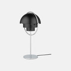 Seen straight on in Black & Chrome, the Clérachic table lamp has both shades rotated back, exposing the two fixed inner cylinders at its centre.