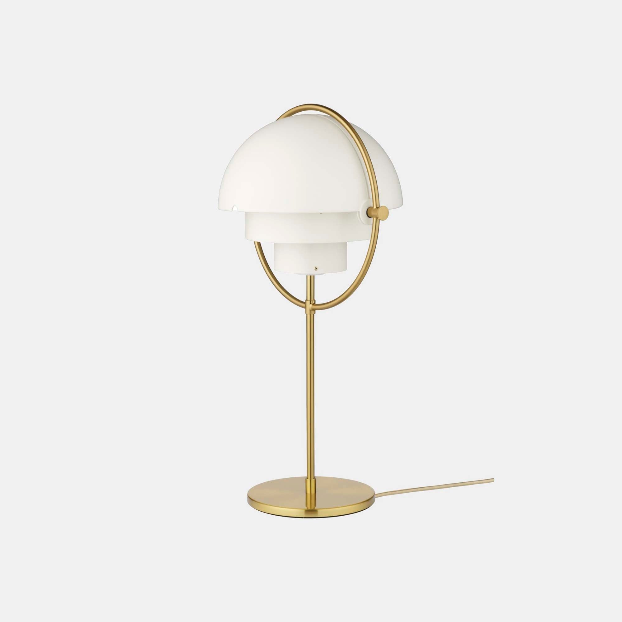 Clérachic's White & Brass table lamp on a plain backdrop, gloss white shades held inside a brushed brass ring above a matching stem and round base.