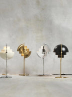 Lined up along a concrete wall, four of the six Clérachic finishes stand side by side, textile cords and inline rocker switches in view.