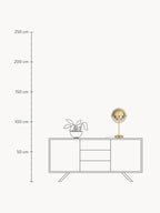Room-context drawing of the Brass Clérachic table lamp on a sideboard, its 50 cm (19.7 in) height measured against a 250 cm (98.4 in) rule.