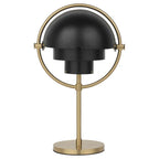 Clérachic rechargeable table lamp in matt black on a brushed brass ring, stem and round base, shades closed.