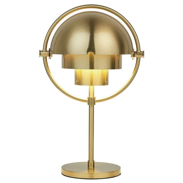 Clérachic table lamp in brushed brass throughout, lit from within so the inner cylinder glows warm.