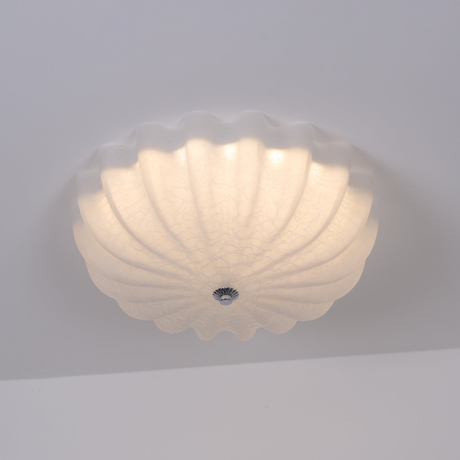 Clérachic Murano-Style Scalloped Glass Flush Ceiling Light lit on a grey ceiling, the craquelé web spreading the glow across the petals.