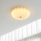 Clérachic Murano-Style Scalloped Glass Flush Ceiling Light in beige, lit warm on a white ceiling beside a tall sheer-curtained window.