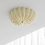 Clérachic Murano-Style Scalloped Glass Flush Ceiling Light in beige, unlit in a quiet corner where the ceiling meets a curtained window.