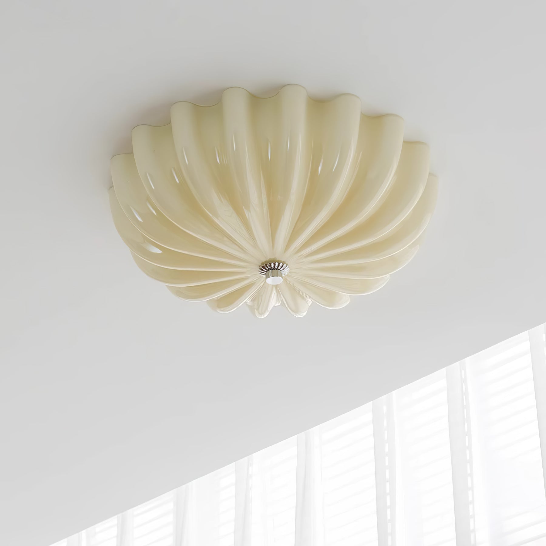 Clérachic Murano-Style Scalloped Glass Flush Ceiling Light in beige, unlit in a quiet corner where the ceiling meets a curtained window.