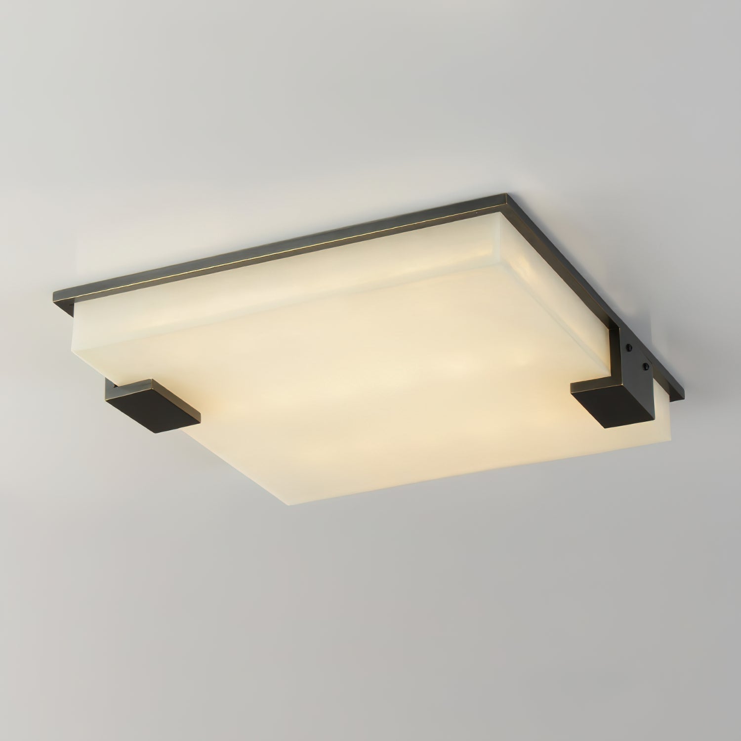 Clérachic alabaster flush mount ceiling light glowing warm against a pale ceiling, its slim dark frame tracing the square diffuser.