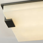 Corner detail of the Clérachic flush mount, the squared bracket clamping the rounded edge of the alabaster panel.
