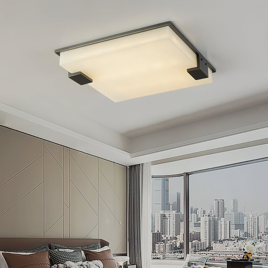 Clérachic ceiling light installed in a modern living room, casting a calm wash over the panelled wall and city window.