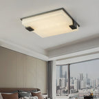 Clérachic ceiling light installed in a modern living room, casting a calm wash over the panelled wall and city window.