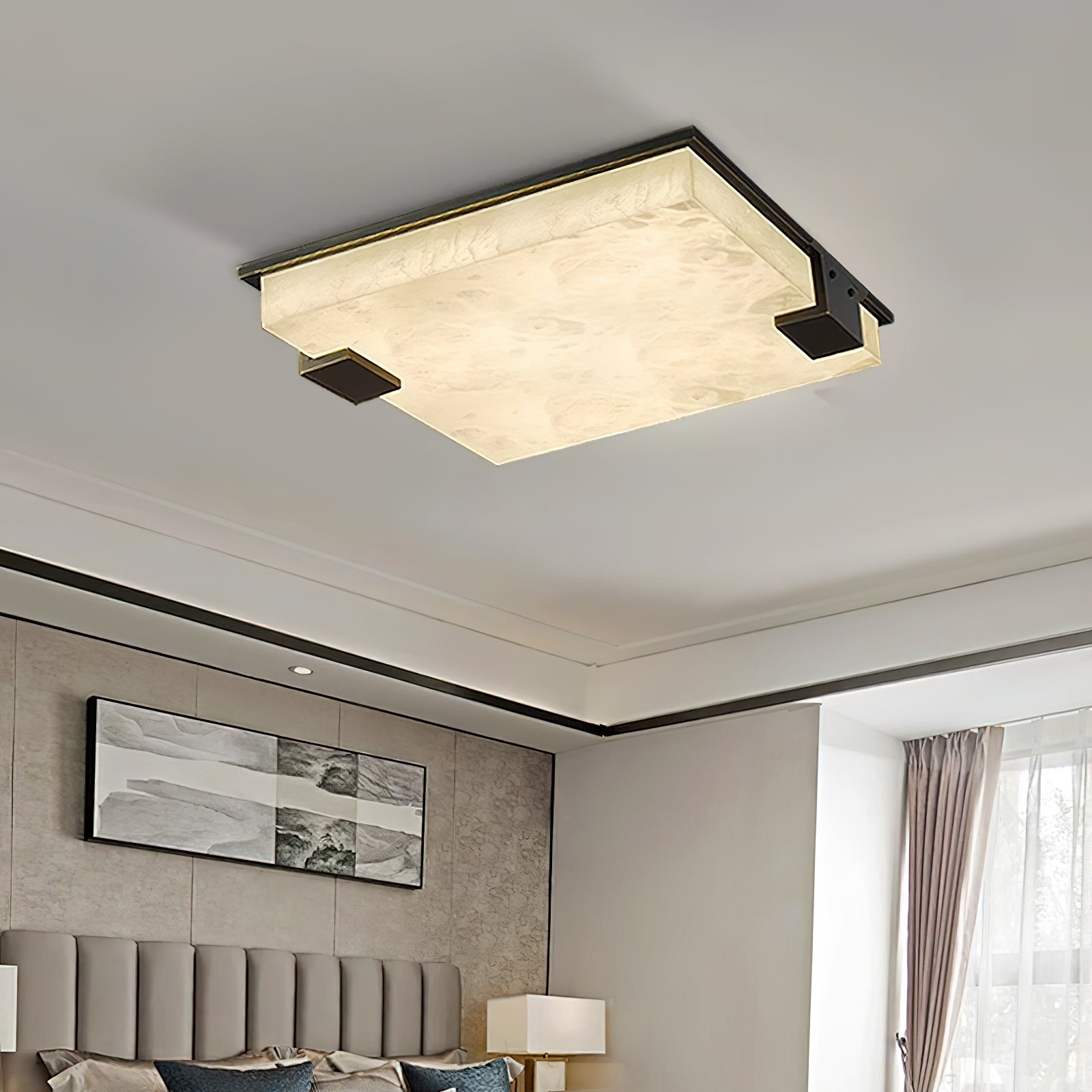 The Clérachic flush mount above a bedroom, veined alabaster glowing softly beside a framed landscape print.