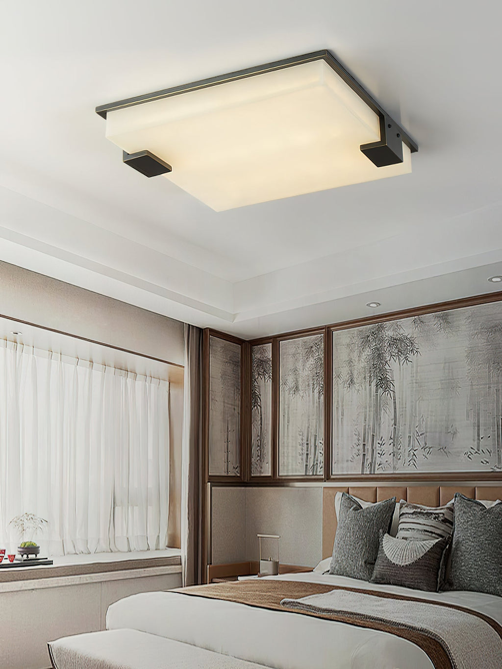The Clérachic light centred on a bedroom ceiling, its soft glow warming timber-framed windows and an upholstered headboard.