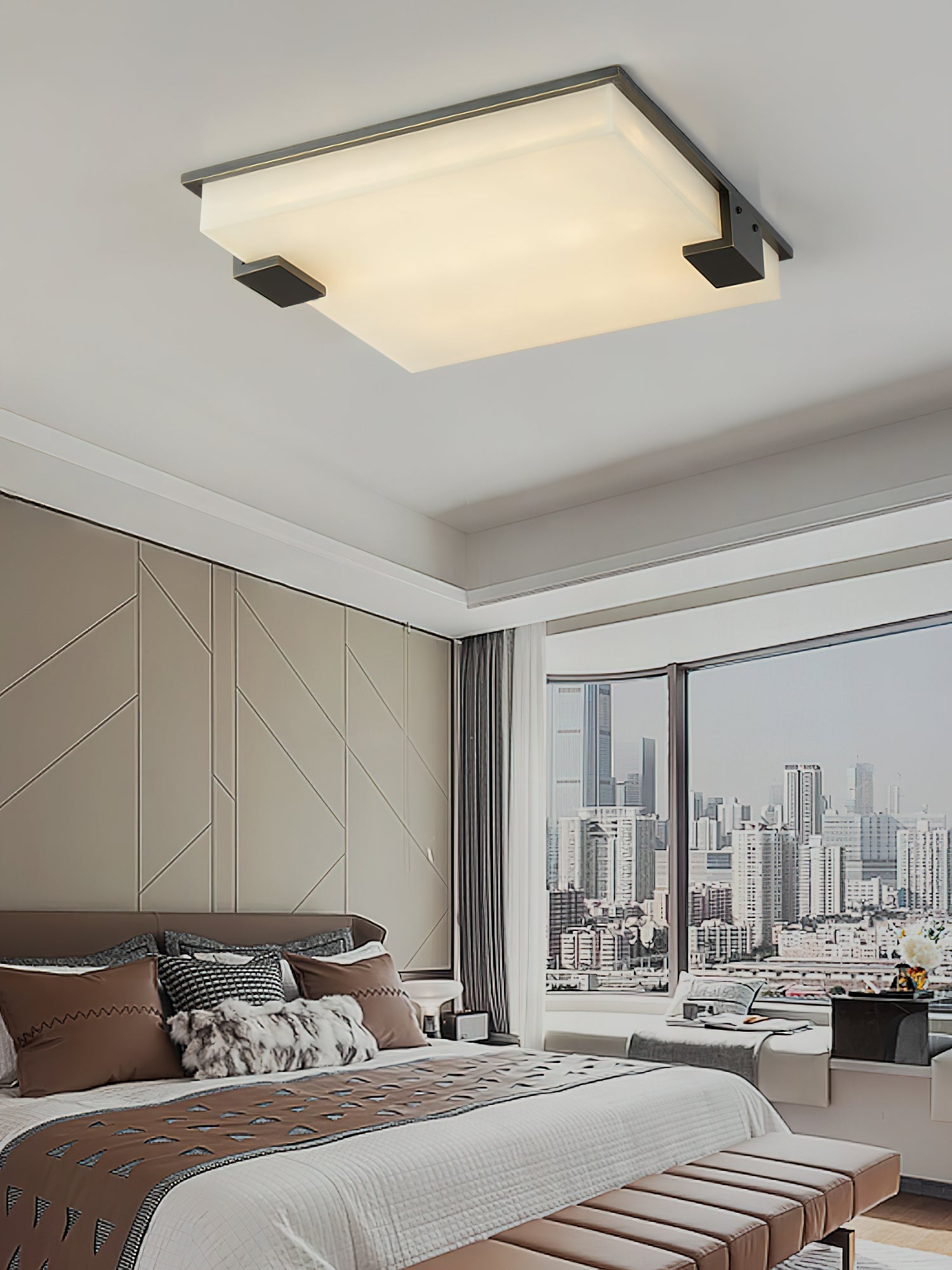 Clérachic flush mount viewed from the bed below, the pale alabaster panel steady against a floor-to-ceiling city view.