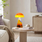 Clérachic mushroom lamp glowing on a pale round side table in a living room, with a stack of books and a stone ornament.
