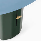 Close view of the brass lever and vertical slot on the green column of this Clérachic table lamp, under the blue shade.