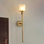 The Clérachic Mycara in copper, lit on a white corner wall beside the edge of a dark framed artwork.