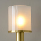 Close crop of the Clérachic Mycara's fluted glass cylinder glowing over its copper collar ring.