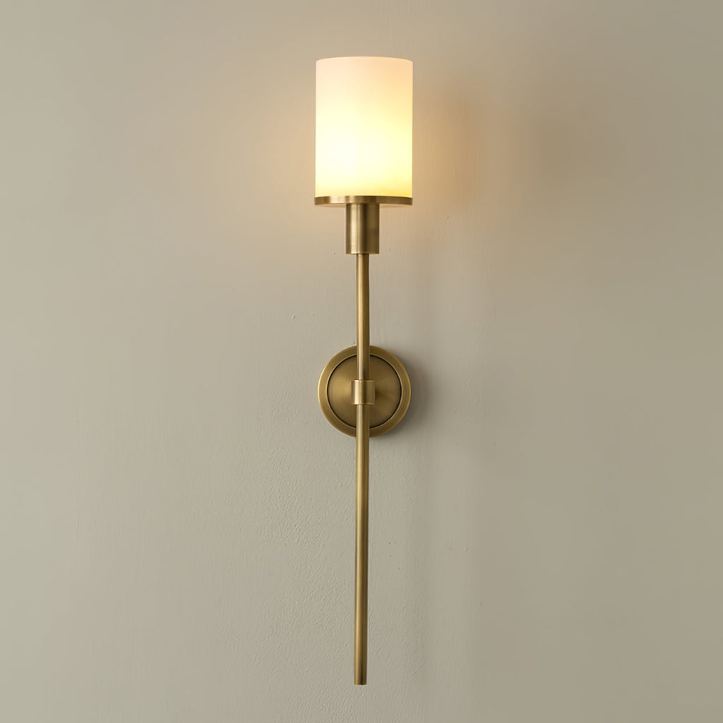 Clérachic Mycara in copper, the glass cylinder lit and the stem tapering to a fine point down the wall.