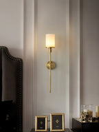 Clérachic Mycara in copper above a dark studded headboard, alabaster shade lit beside gilt bedside frames.